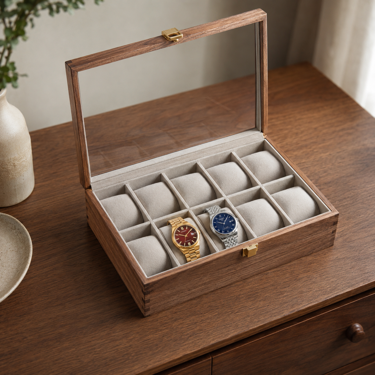Horae walnut watch box viewed at three-quarters with the glass lid open above filled slots